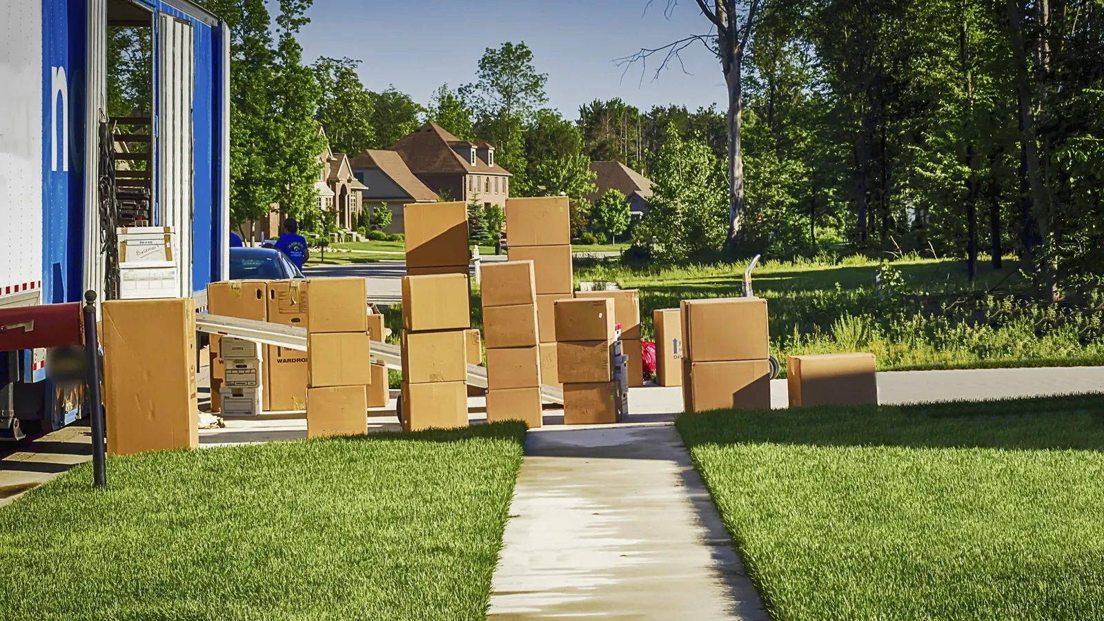 Boxes and belongings being cleared from a suburban home into a truck